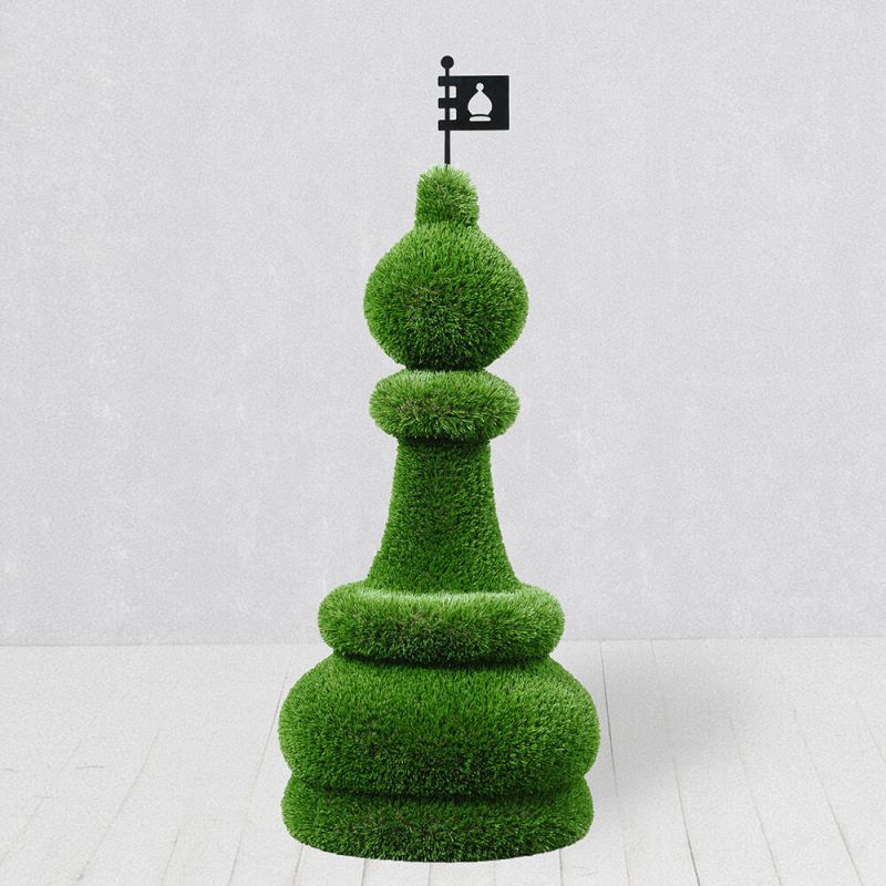 Grande pièce d'échecs verte en décoration végétale sur un sol en bois