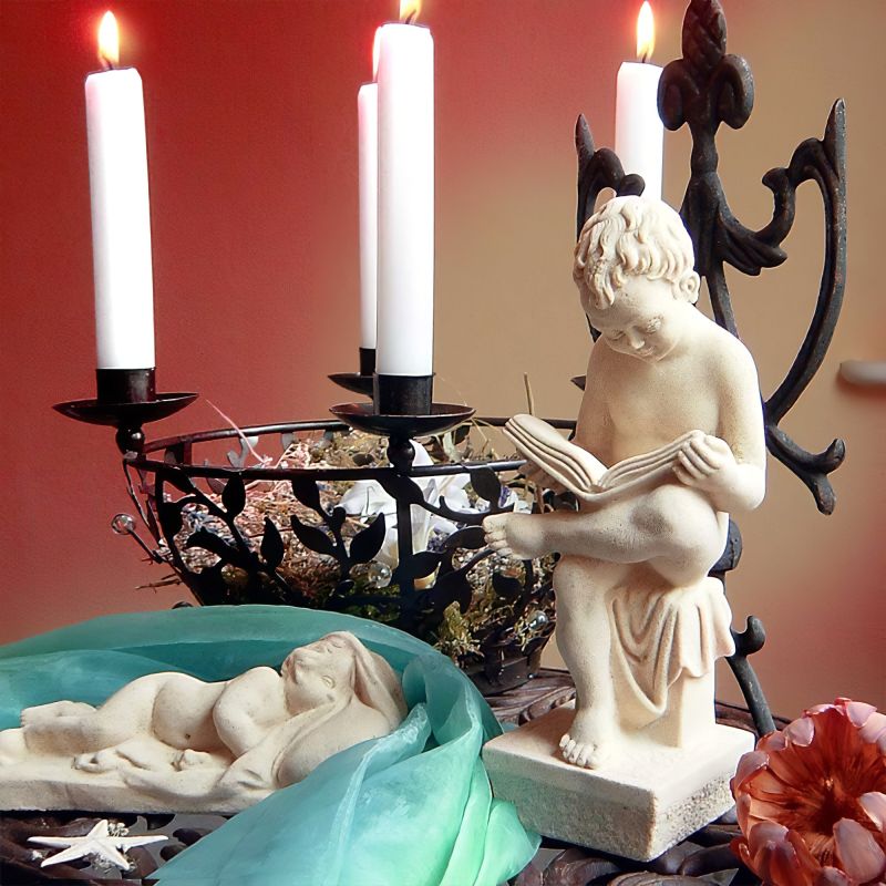 Bougeoir blanc avec une statue d'ange et des bougies décoratives, parfait pour le jardin